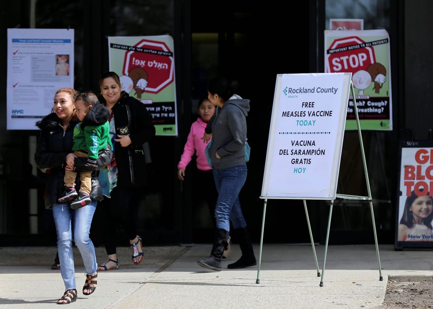 Sign advertising free measles vaccines and information about measles are displayed at the Rockland County Health Department in Pomona, N.Y., Wednesday, March 27, 2019. The county in New York City's northern suburbs declared a local state of emergency Tuesday over a measles outbreak that has infected more than 150 people since last fall, hoping a ban against unvaccinated children in public places wakes their parents to the seriousness of the problem. (AP Photo/Seth Wenig)