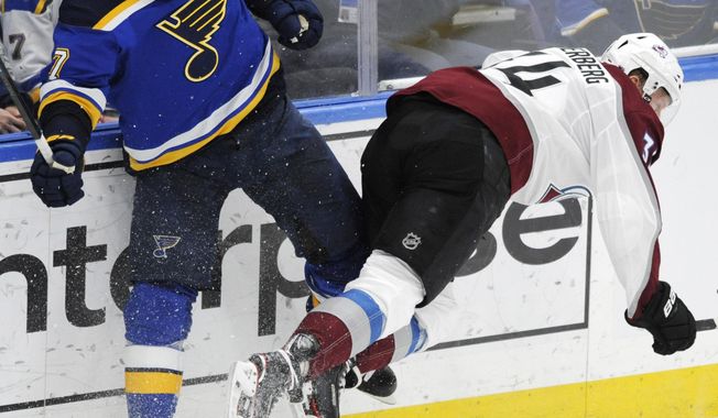 Colorado Avalanche&#x27;s Carl Soderberg (34), of Sweden, is checked by St. Louis Blues&#x27; Pat Maroon (7) during the third period of an NHL hockey game, Monday, April 1, 2019, in St. Louis. (AP Photo/Bill Boyce)