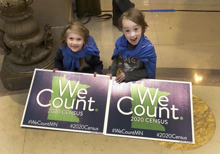 Noelle Fries, 6, left, and Galen Biel, 6, both of Minneapolis, attend a rally at the Minnesota Capitol on Monday, April 1, 2019, to kick off a year-long drive to try to ensure that all Minnesota residents are counted in the 2020 census. Officials say the census historically undercounts children. (AP Photo/Steve Karnowski)