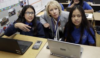 U.S. Education Secretary Betsy DeVos talks with students in a sixth grade math class at Cameron Middle School Monday, April 1, 2019, in Nashville, Tenn. DeVos said she&#x27;s encouraged by Tennessee&#x27;s latest push to expand school vouchers throughout the state and said she&#x27;s cheering on lawmakers to make the right choice. (AP Photo/Mark Humphrey)