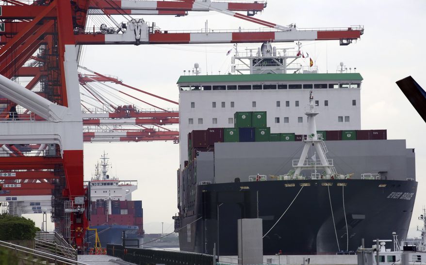 FILE - In this June 18, 2018, file photo, a container ship, right, arrives at a container terminal in Tokyo. The latest surveys of Japanese manufacturers are pointing to a slowdown for the world’s third-largest economy. The Bank of Japan’s quarterly “tankan” survey of major manufacturers on Monday showed a deterioration in confidence in March compared with December. (AP Photo/Koji Sasahara, File)