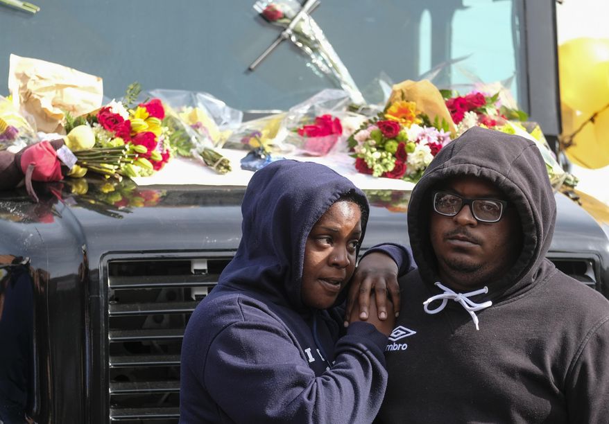 Fans of rapper Nipsey Hussle mourn his death at a makeshift memorial on the parking lot of the Marathon Clothing store in Los Angeles, Monday, April 1, 2019. Hussle was killed on Sunday in a shooting outside the clothing store he founded in South Los Angeles. (AP Photo/Ringo H.W. Chiu)