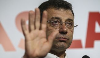 Ekrem Imamoglu, the candidate from an alliance led by the secular Republican People&#39;s Party, (CHP) gestures as he declares victory during a news conference in Istanbul, Monday April 1, 2019. Unofficial results by state-run Anadolu news agency said he had won 48.8 percent of the vote Sunday and his opponent, former Prime Minister Binali Yildirim of the ruling party, had captured 48.5 percent. One percent of the votes were still to be counted. (AP Photo/Emrah Gurel)