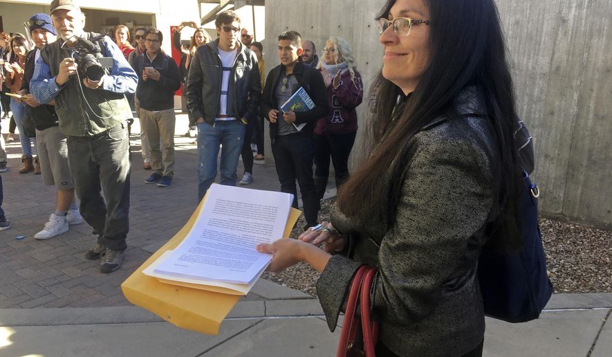 FILE - In this Nov. 18, 2016 file photo, University of New Mexico Chicana and Chicano studies professor Irene Vasquez holds a letter with hundreds of signatures, asking school president Bob Frank to declare the campus a "sanctuary university," in Albuquerque, N.M. Vasquez and other Mexican American scholars from universities across the country are gathering in Albuquerque on Wednesday, April 3, 2019, for an annual four-day national conference amid uncertainty on immigration and ethnic studies battles on college campuses. (AP Photo/Russell Contreras, File)