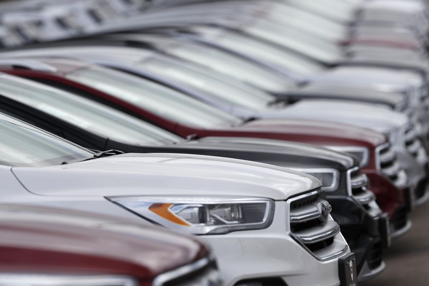 FILE- In this Sunday, Feb. 17, 2019, file photo, unsold 2019 Escape sports-utility vehicles sit in a long row at a Ford dealership in Broomfield, Colo. On Tuesday, April 2, the Commerce Department releases its February report on durable goods. (AP Photo/David Zalubowski, File)