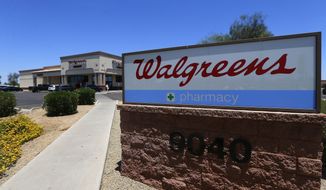 FILE- In this June 25, 2018, file photo shows a Walgreens store in Peoria, Ariz. Walgreens Boots Alliance, Inc. reports financial earns on Tuesday, April 2, 2019. (AP Photo/Ross D. Franklin, File)