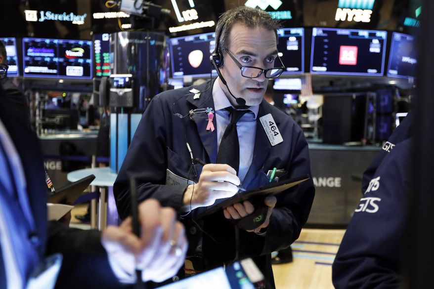 FILE- In this March 5, 2019, file photo trader Gregory Rowe works on the floor of the New York Stock Exchange. The U.S. stock market opens at 9:30 a.m. EDT on Tuesday, April 2. (AP Photo/Richard Drew, File)
