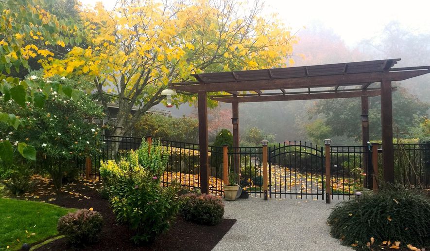 This Oct. 19, 2018 photo shows a pergola used to enhance a front entry at a home near Langley, Wash. Many of these structures are being upgraded with lighting and retractable shades to cover outdoor entertainment areas. (AP Photo/By Dean Fosdick)