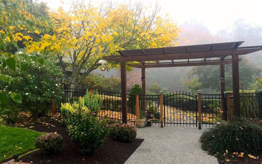This Oct. 19, 2018 photo shows a pergola used to enhance a front entry at a home near Langley, Wash. Many of these structures are being upgraded with lighting and retractable shades to cover outdoor entertainment areas. (AP Photo/By Dean Fosdick)