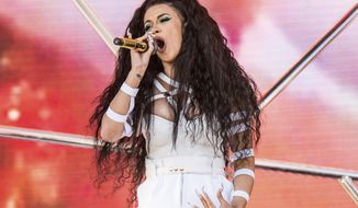 FILE- In this April 22, 2018 file photo, Cardi B performs at the Coachella Music &amp;amp; Arts Festival at the Empire Polo Club in Indio, Calif. Cardi B and Travis Scott are heading to the City of Brotherly Love to headline Jay-Z’s annual Made in America festival in Philadelphia on Aug. 31-Sept. 1 for Labor Day weekend. (Photo by Amy Harris/Invision/AP, File)