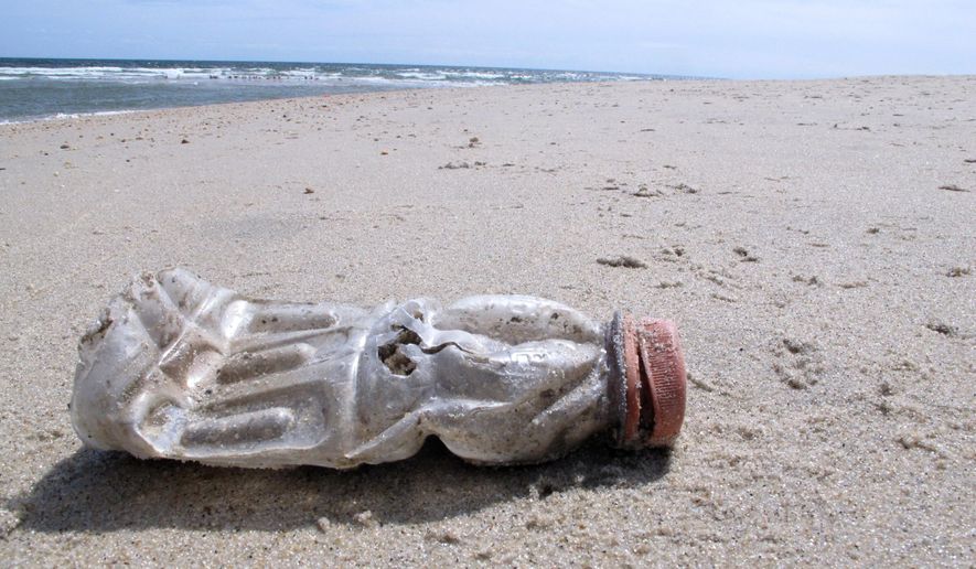 A discarded plastic bottle lies on the beach at Sandy Hook, N.J., on Tuesday, April 2, 2019, the same day as a report released by the environmental group Clean Ocean Action found that volunteers picked up more than 450,000 pieces of litter from New Jersey&#x27;s coastline last year. (AP Photo/Wayne Parry) ** FILE **