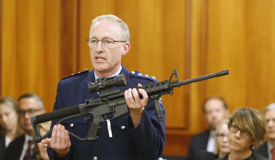 Police acting superintendent Mike McIlraith shows New Zealand lawmakers in Wellington on April 2, 2019, an AR-15 style rifle similar to one of the weapons a gunman used to slaughter 50 people at two mosques. New Zealand lawmakers on Tuesday voted overwhelmingly in favor of new gun control measures during the first stage of a bill they hope to rush into law by the end of next week. (AP Photo/Nick Perry)