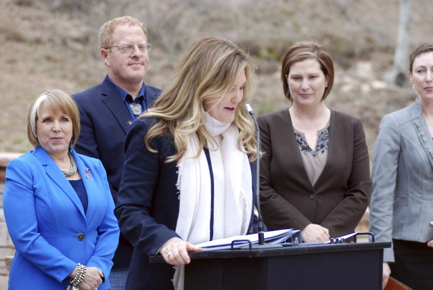 New Mexico Economic Development Secretary Alicia Keyes (center, at microphone) helps announce the creation of an outdoor recreation division on Tuesday, April 2, 2019, in Hyde Memorial State Park outside Santa Fe, N.M. Gov. Michelle Lujan Grisham (far left) signed a bill that creates the agency and a grant fund to support childhood outdoor adventures. She is joined by Democratic state Sen. Jeff Steinborn (left center) of Las Cruces and Tourism Secretary Jen Schroer (right). New Mexico is seeking a bigger share of the nation's outdoor recreation economy and hopes the state's natural wonders can entice new residents and businesses. (AP Photo/Morgan Lee)