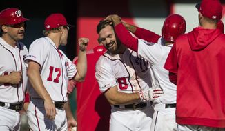 Washington Nationals&#39; Jake Noll, center, celebrates with his teammates after a baseball game against the Philadelphia Phillies at Nationals Park, Wednesday, April 3, 2019, in Washington. Noll drew a walk to force in the winning run. The Nationals won 9-8. (AP Photo/Alex Brandon)