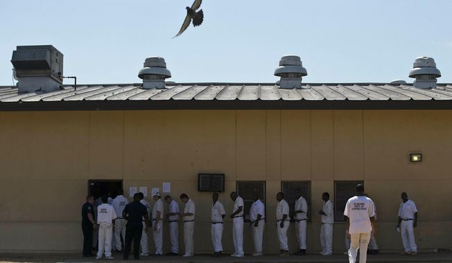 FILE - In this June 18, 2015, file photo, prisoners stand in a crowded lunch line during a prison tour at Elmore Correctional Facility in Elmore, Ala. The Justice Department has determined that Alabama&#x27;s prisons are violating the Constitution by failing to protect inmates from violence and sexual abuse and by housing them in unsafe and overcrowded facilities, according to a scathing report Wednesday, April 3, 2019, that described the problems as &amp;quot;severe&amp;quot; and &amp;quot;systemic.&amp;quot; (AP Photo/Brynn Anderson, File)