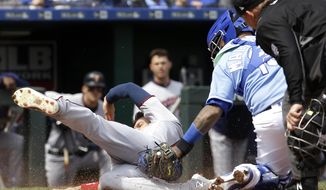 Minnesota Twins&#39; Jake Cave (60) is tagged out at home by Kansas City Royals catcher Martin Maldonado as he tried to score on an RBI double by Mitch Garver during the fourth inning of a baseball game Wednesday, April 3, 2019, in Kansas City, Mo. (AP Photo/Charlie Riedel)