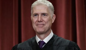 FILE - In this Nov. 30, 2018 file photo, Associate Justice Neil Gorsuch, appointed by President Donald Trump, sits with fellow Supreme Court justices for a group portrait at the Supreme Court Building in Washington. Supreme Court Justice Gorsuch has a collection of speeches, writings and original essays coming out this fall. Crown Forum, a conservative imprint at Penguin Random House, announced Wednesday, April 3, 2019, that Gorsuch’s “A Republic, If You Can Keep It” is scheduled for Sept. 10. (AP Photo/J. Scott Applewhite, File)