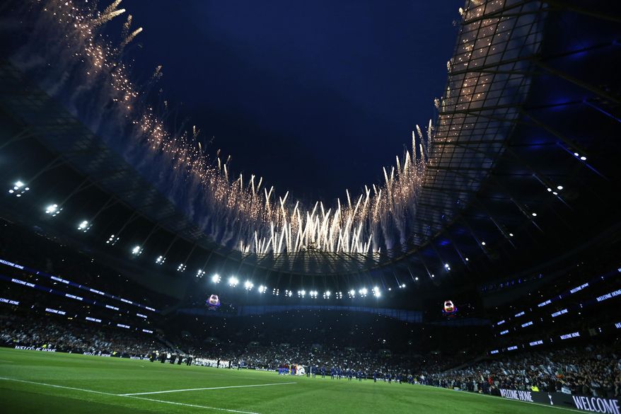 Fireworks explode above the stadium as the teams stand on the pitch before the start of the English Premier League soccer match between Tottenham Hotspur and Crystal Palace, the first Premiership match at the new Tottenham Hotspur stadium in London, Wednesday, April 3, 2019. (AP Photo/Kirsty Wigglesworth)