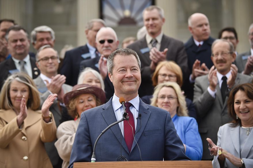 State Sen. Albert Olszewski, who ran in the Republican U.S. Senate primary last year, announces Wednesday, April 3, 2019 he's joining the race for governor in 2020 on the step of the Montana State Capitol in Helena, Mont. (Thom Bridge/Independent Record via AP)