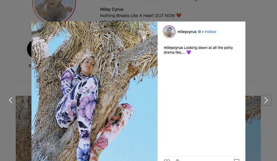 This image posted on the Instagram account of actress and singer Miley Cyrus shows her sitting in a Joshua Tree. Photos posted on her Instagram account showing Cyrus posing in a Joshua tree have drawn criticism from people concerned about protecting the iconic desert species. Joshua trees are protected in Joshua Tree National Park and the Mojave National Preserve as well as under some city and county ordinances. National Park spokesman George Land expressed concern that the singer's many followers might copy her actions. (Instagram via AP)