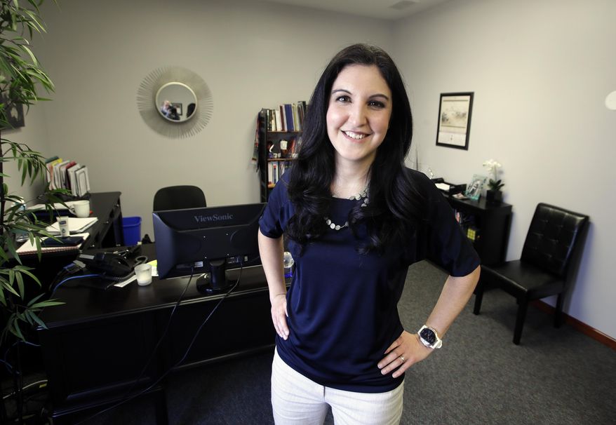 In this March 26, 2019, photo Victoria Bogner poses for a photo in her office in Lawrence, Kan. While burnout is common with workers, students and caregivers, it’s particularly frustrating for entrepreneurs. Bogner, who describes herself as a perfectionist and control freak, burned out after becoming head of two financial advisory firms. “I eventually found myself spinning some huge plates as a CEO, chief investment officer, and a financial advisor with my own clientele,” says Bogner. (AP Photo/Orlin Wagner)