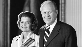 President Gerald R. Ford and first lady Betty Ford smile as they listen to applause after he was sworn in as the nation&#39;s chief executive at the White House, Aug. 9, 1974. (AP Photo)