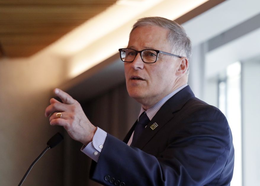 Gov. Jay Inslee addresses a workshop about transportation electrification Thursday, April 4, 2019, in Seattle. The third of four regional workshops, sponsored by the National Governors Association, is to help states develop strategies and improve the planning and deployment of charging infrastructure, as well as electric vehicle (EV) incentive programs. The association representing the 55 governors of states and territories has been working with state and industry leaders to develop and implement best practices across states to accommodate the adoption of electric vehicle technologies. (AP Photo/Elaine Thompson)