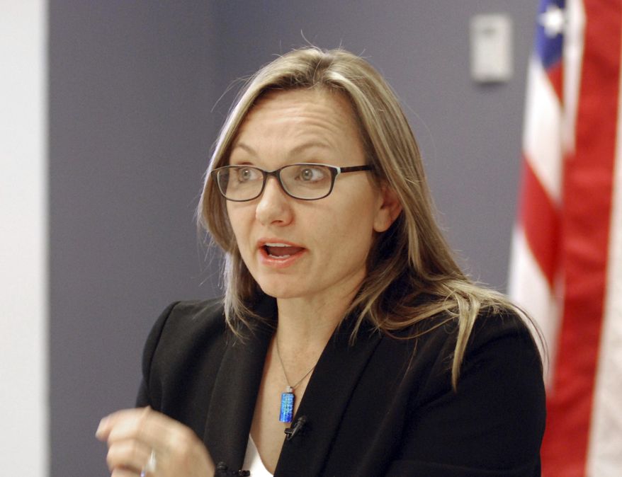 New Mexico state Homeland Security Secretary Jackie White briefs reporters on Thursday, April 4, 2019, at emergency management offices on the outskirts of Santa Fe, N.M. White said that pressure from migrants seeking asylum in the U.S. was being felt at ports of entry in neighboring El Paso, Texas, and not along New Mexico's portion of the border during March. (AP Photo/Morgan Lee)