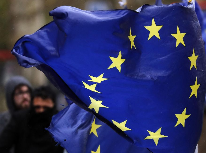 European flags fly, opposite the Houses of Parliament in London, Thursday, April 4, 2019. The British government and senior opposition figures were meeting Thursday in search of a new plan on how the country leaves the European Union as Prime Minister Theresa May tried to stop her shift toward compromise from splitting her Conservative Party. (AP Photo/Frank Augstein)