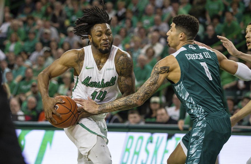 Marshall's C.J. Burks (14) drives the the basket against Green Bay's Sandy Cohen (1) in the championship game of the CollegeInsider.com Tournament on Thursday, April 4, 2019, at the Cam Henderson Center in Huntington, W.Va. (Sholten Singer/The Herald-Dispatch via AP)
