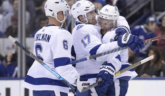 Tampa Bay Lightning left wing Alex Killorn (17) celebrates his goal against the Toronto Maple Leafs with teammates Anton Stralman (6) and Steven Stamkos (91) during third period NHL hockey action in Toronto on Thursday, April 4, 2019. (Nathan Denette/The Canadian Press via AP)