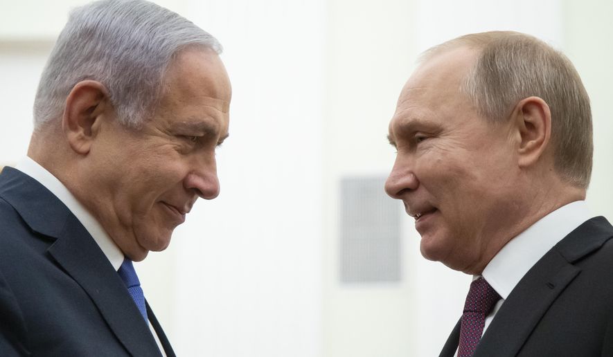 Russian President Vladimir Putin, right, and Israeli Prime Minister Benjamin Netanyahu greet each other during their meeting in the Kremlin in Moscow, Russia, Thursday, April 4, 2019. (AP Photo/Alexander Zemlianichenko, Pool)