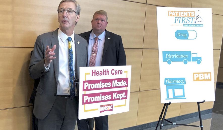 Minnesota State Sen. Scott Jensen, R-Chaska, left, discusses Senate GOP-backed health care legislation at a news conference on Thursday, April 4, 2019 in St. Paul, Minn. Jensen is chief author of a bill regulating pharmacy benefit managers that passed the Senate later the same day. (AP Photo/Steve Karnowski)