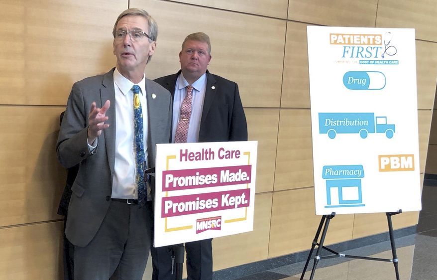 Minnesota State Sen. Scott Jensen, R-Chaska, left, discusses Senate GOP-backed health care legislation at a news conference on Thursday, April 4, 2019 in St. Paul, Minn. Jensen is chief author of a bill regulating pharmacy benefit managers that passed the Senate later the same day. (AP Photo/Steve Karnowski)