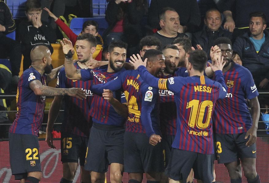 Barcelona forward Luis Suarez celebrates with teammates after scoring his side's fourth goal during the Spanish La Liga soccer match between Villarreal and FC Barcelona at the Ceramica stadium in Villarreal, Spain, Tuesday, April 2, 2019.(AP Photo/Alberto Saiz)