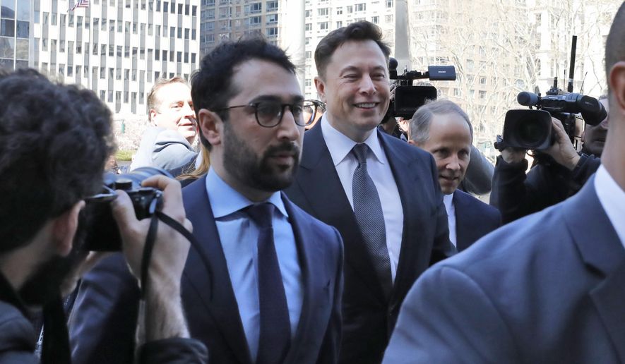 Tesla CEO Elon Musk, center, arrives at Manhattan Federal Court, in New York, Thursday, April 4, 2019. Musk and his lawyers were appearing before a federal judge in New York who will decide whether the Tesla CEO should be held in contempt of court for violating an agreement with the U.S. Securities and Exchange Commission.(AP Photo/Richard Drew)