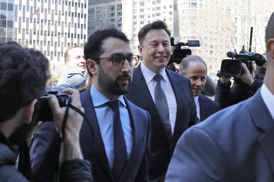 Tesla CEO Elon Musk, center, arrives at Manhattan Federal Court, in New York, Thursday, April 4, 2019. Musk and his lawyers were appearing before a federal judge in New York who will decide whether the Tesla CEO should be held in contempt of court for violating an agreement with the U.S. Securities and Exchange Commission.(AP Photo/Richard Drew)