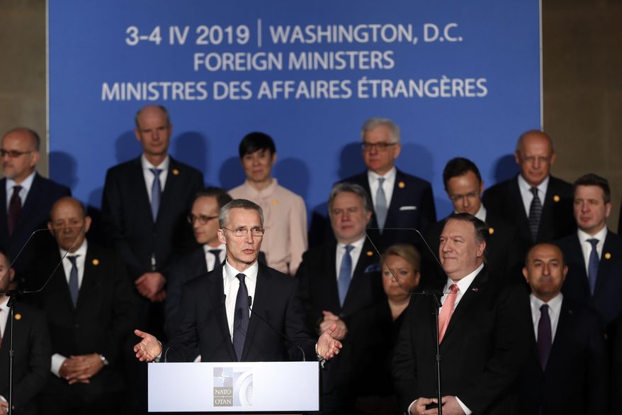 NATO Secretary General Jens Stoltenberg with Secretary of State Mike Pompeo, at front right, speaks during remarks to commemorate NATO's 70th anniversary during a ceremony at Mellon Auditorium in Washington, Wednesday, April 3, 2019. (AP Photo/Pablo Martinez Monsivais)