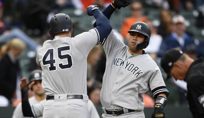New York Yankees&#x27; Luke Voit (45) celebrates his three-run home run with Gary Sanchez, right, during the ninth inning of the team&#x27;s baseball game against the Baltimore Orioles, Thursday, April 4, 2019, in Baltimore. The Yankees won 8-4. (AP Photo/Nick Wass)