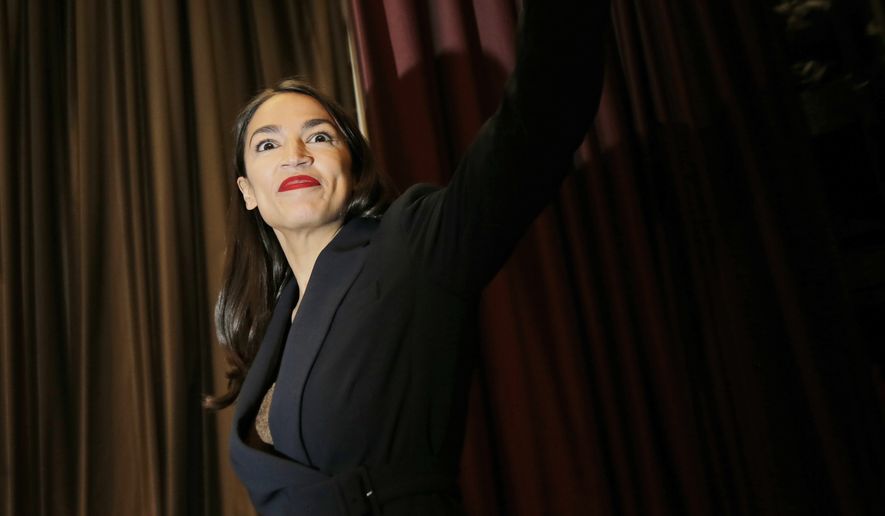 Rep. Alexandria Ocasio-Cortez, D-N.Y., arrives on the stage before speaking during the National Action Network Convention in New York, Friday, April 5, 2019. (AP Photo/Seth Wenig)