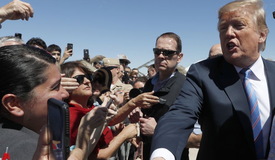 President Donald Trump greets people after he arrived on Air Force One at Naval Air Facility El Centro, in El Centro, Calif., Friday April 5, 2019. (AP Photo/Jacquelyn Martin)