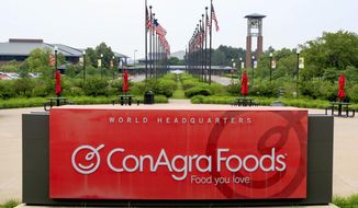 FILE - In this June 30, 2015, file photo, flags fly over ConAgra Foods world headquarters in Omaha, Neb. Conagra is recalling some Hunt’s tomato paste cans due to the possibility of mold. The company said that the recall is for six ounce cans of Hunt’s Tomato Paste No Salt Added. (AP Photo/Nati Harnik, File)