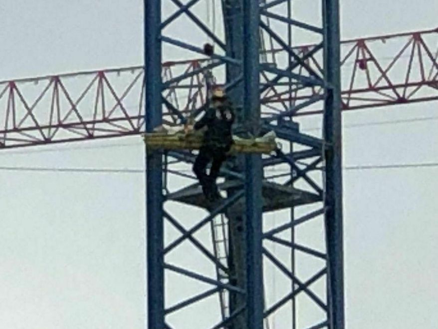 In this image take from video, Cincinnati Fire Department rescue a worker after his arm was partially severed in an accident nearly 300 feet up in the air, Friday, April 5, 2019, in Cincinnati. A fire official says the crane operator made the call after a cable sliced underneath his arm. (WCPO via AP)