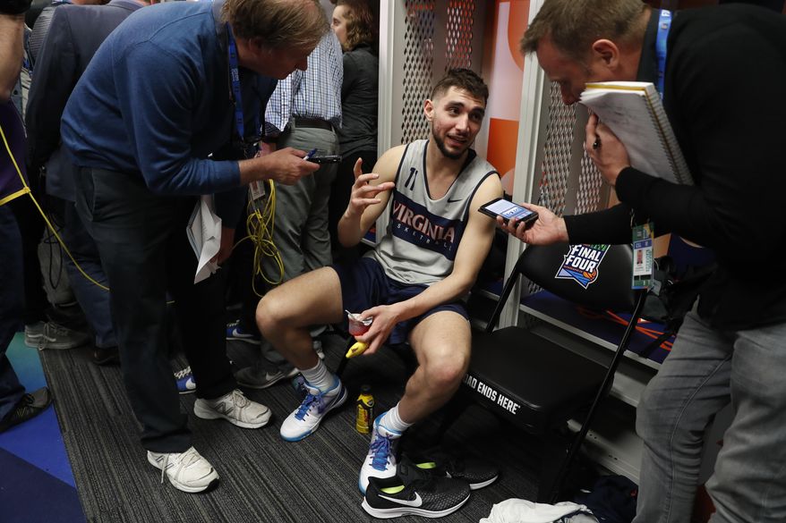 Virginia's Ty Jerome answers questions after a practice session for the semifinals of the Final Four NCAA college basketball tournament, Thursday, April 4, 2019, in Minneapolis. (AP Photo/Jeff Roberson)