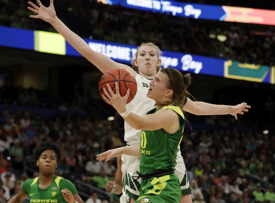 Oregon guard Sabrina Ionescu (20) drives to the basket as Baylor forward Lauren Cox (15), defends during a women's Final Four NCAA college basketball semifinal tournament game Friday, April 5, 2019, in Tampa, Fla. (AP Photo/Chris O'Meara)