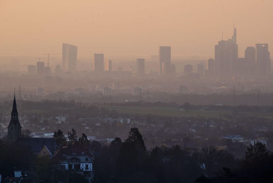 The European Central Bank, left, and other banks and office buildings are seen in Frankfurt, Germany, before sunrise on Friday, March 29, 2019. (AP Photo/Michael Probst)