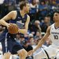 Dallas Mavericks forward Dirk Nowitzki looks to pass against Memphis Grizzlies forward Ivan Rabb (10) during the first half of an NBA basketball game in Dallas, Friday, April 5, 2019. (AP Photo/LM Otero)