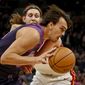 Minnesota Timberwolves forward Dario Saric, front, drives to the basket around Miami Heat forward Kelly Olynyk in the first quarter of an NBA basketball game Friday, April 5, 2019, in Minneapolis. (AP Photo/Bruce Kluckhohn)