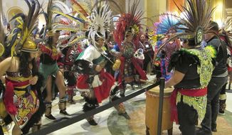 Indigenous Latin American dancers perform outside the chamber of the Minnesota House on Friday, March 5, 2019, as representatives debate a bill that would allow all Minnesota residents to obtain driver&#39;s licenses regardless of their immigration status. (AP Photo/Steve Karnowski)
