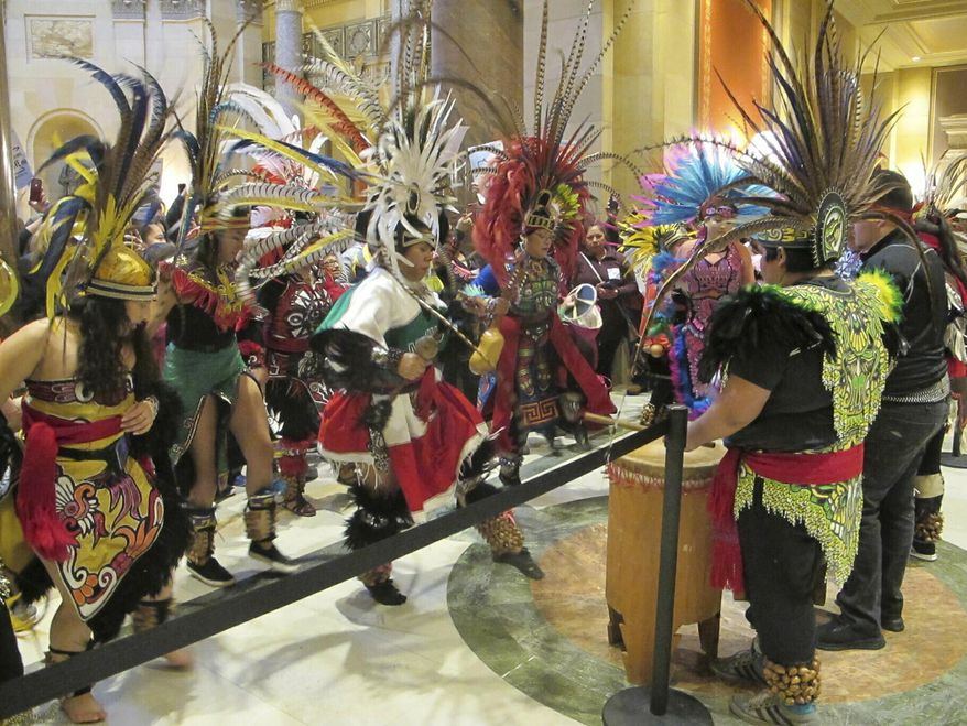 Indigenous Latin American dancers perform outside the chamber of the Minnesota House on Friday, March 5, 2019, as representatives debate a bill that would allow all Minnesota residents to obtain driver's licenses regardless of their immigration status. (AP Photo/Steve Karnowski)